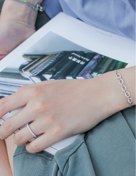 Close-up of a woman's hand wearing a bracelet and ring, promoting the mori Loyalty Programme